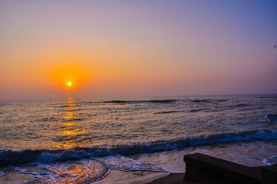 Scenic view of sea against orange sky