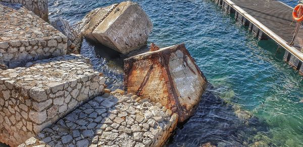 High angle view of stones by sea