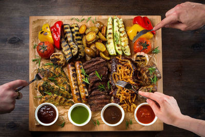 A board with grilled appetizers and sauces. grilled vegetables and meats and sausages