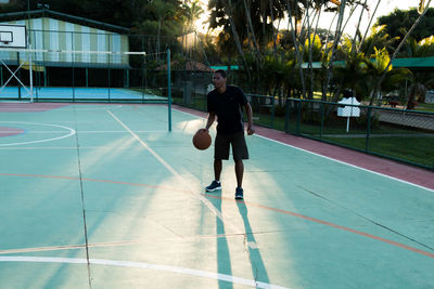 Full length of man playing basketball