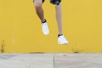 Disabled athlete jumping on street