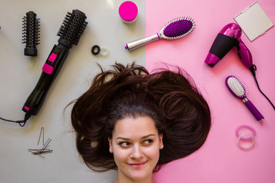 Woman with brown hair by personal accessories on table