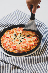 Close-up of hand holding pizza