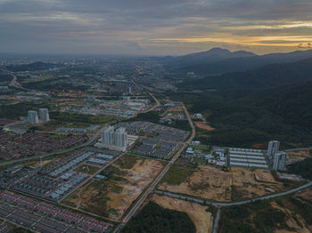 High angle view of buildings in city during sunset