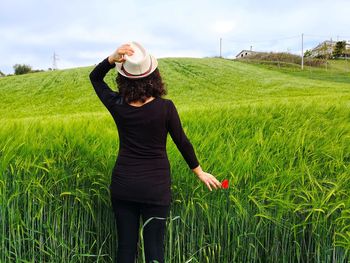 Woman in green wheat field