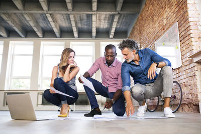 Team of architects discussing the rebuilding of a loft office