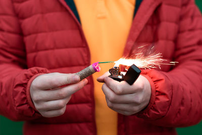 Midsection of woman with fire crackers