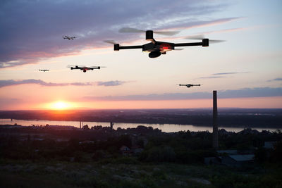 Airplane flying in sky during sunset