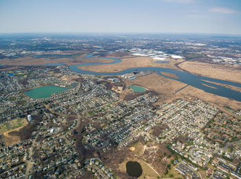 Aerial view of buildings and sea against sky