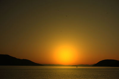 Scenic view of sea against orange sky