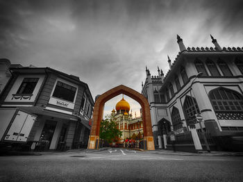 Facade of church against cloudy sky