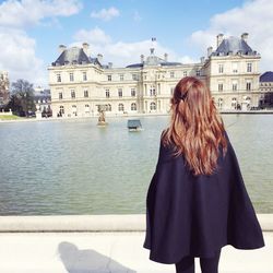 Rear view of woman standing in river