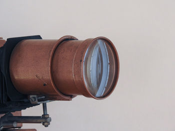 Close-up of retro camera against gray background