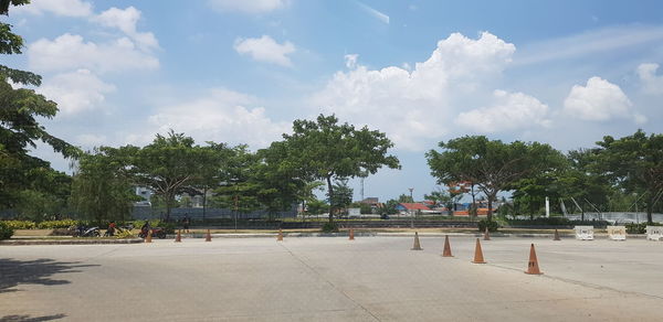 People on street in park against sky