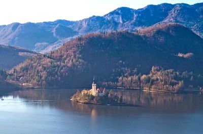 Scenic view of lake by buildings against sky