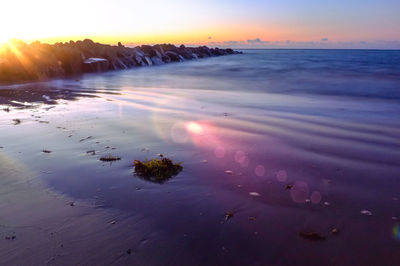 Scenic view of sea against sky at sunset