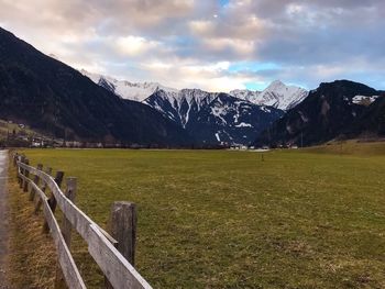 Scenic view of field and mountains against sky