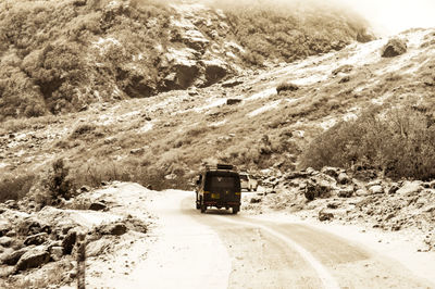 Road by snow covered land