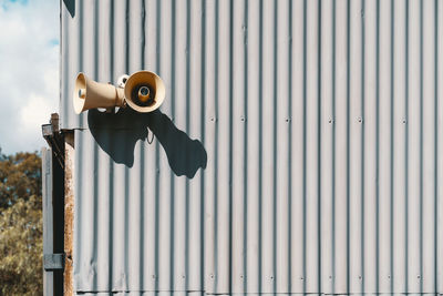 Low angle view of megaphone on wall outdoors