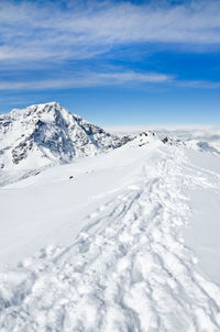 Scenic view of snow covered mountains against sky