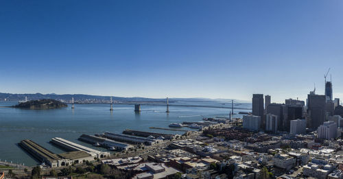 High angle view of bay and buildings against clear sky
