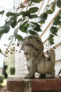 Statue of tree against plants