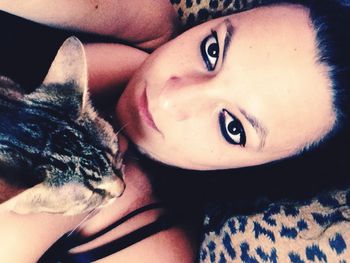 Portrait of young woman lying on bed