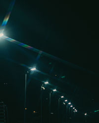 Low angle view of illuminated buildings against sky at night