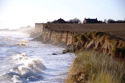 Scenic view of beach against clear sky