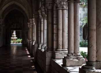 Stone columns along dark corridor 