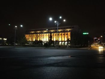 Illuminated city street at night