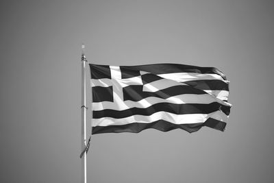 Low angle view of flag against clear sky