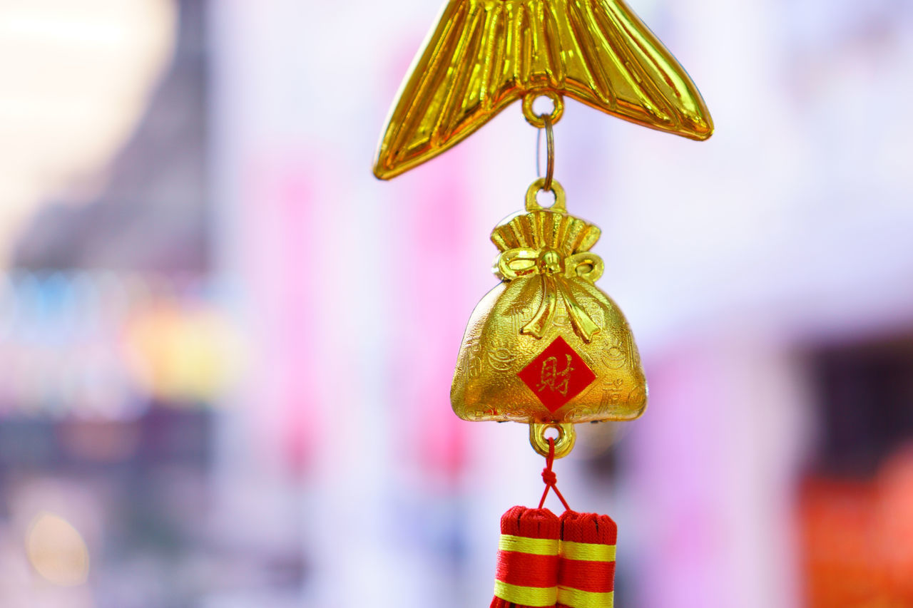 CLOSE-UP OF DECORATION HANGING AT MARKET STALL