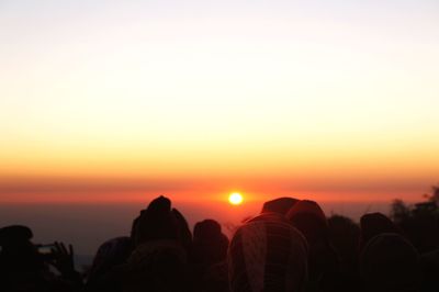 Silhouette people against sky during sunset