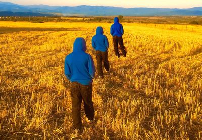 Multiple image of man walking on field