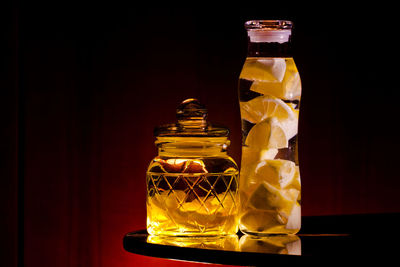 Close-up of glass jar against black background