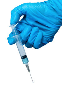 Low angle view of human hand against blue background