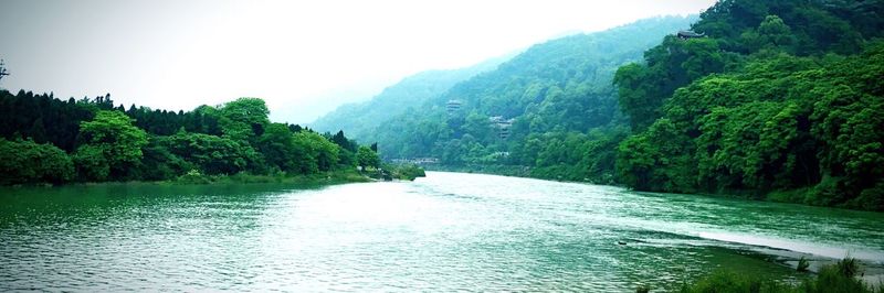 Scenic view of river with mountains in background