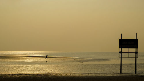 Scenic view of sea against clear sky during sunset