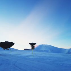 Scenic view of snow covered landscape against blue sky