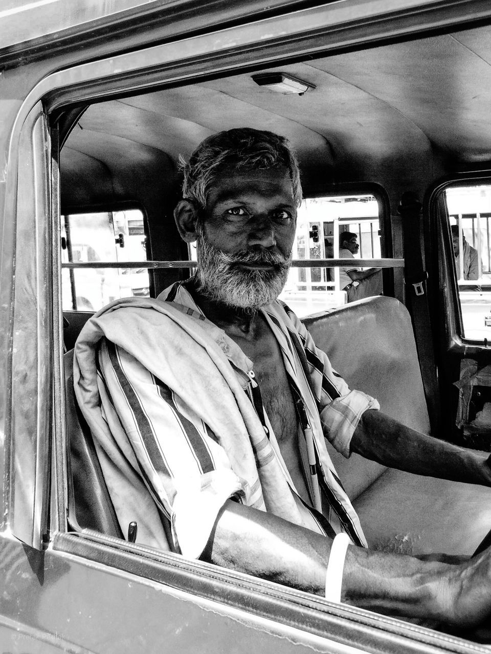 mode of transportation, transportation, portrait, one person, window, public transportation, land vehicle, real people, train, beard, rail transportation, looking at camera, vehicle interior, facial hair, males, train - vehicle, men, mature adult, mature men, outdoors