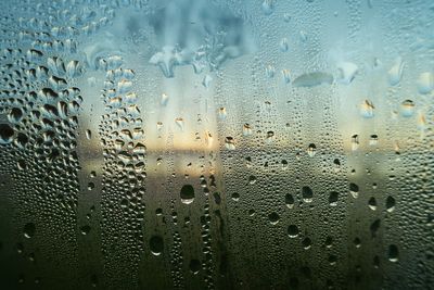 Full frame shot of raindrops on glass window