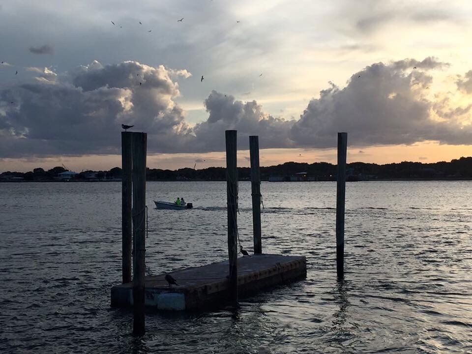 water, sky, tranquil scene, tranquility, rippled, scenics, cloud - sky, nature, beauty in nature, cloud, sunset, idyllic, cloudy, wooden post, no people, outdoors, non-urban scene, calm, remote, day, ocean