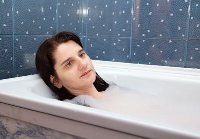 Close-up of thoughtful woman in bathtub