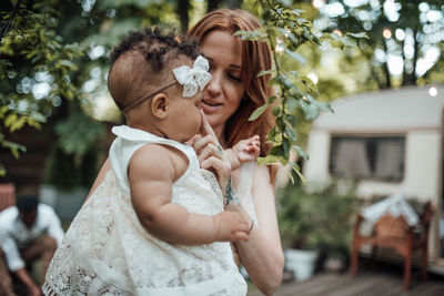 Midsection of mother and daughter woman outdoors