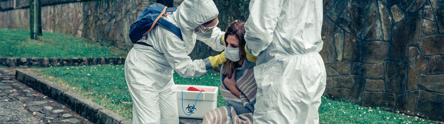 Doctors examining woman outdoors