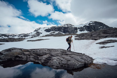 Scenic view of snow covered mountains against cloudy sky