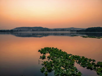 Scenic view of lake against sky during sunset