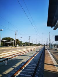 Railroad station platform against clear sky