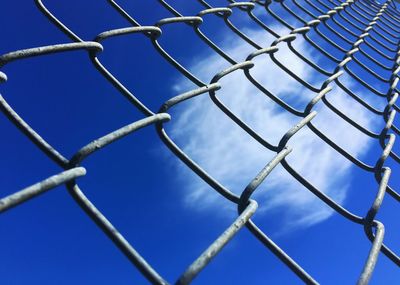 Full frame shot of chainlink fence against sky